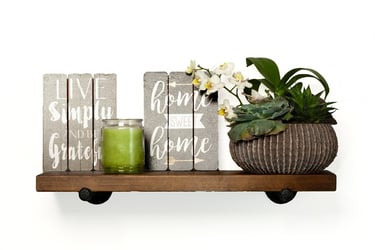 Mounted wooden shelf supporting 6 books, green candle, and a plant. # Detroit Commercial Photography, # Branding Photographe