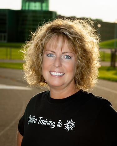 Outdoor headshot with running track in background for physical training company. # # Business Headshot, # Professional Headsh