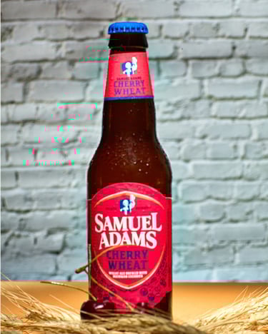 Samuel Adams Cherry Wheat beer with red cherries and wheat stalk on a set with brick wall. #Detroit Food Photography, #Food P