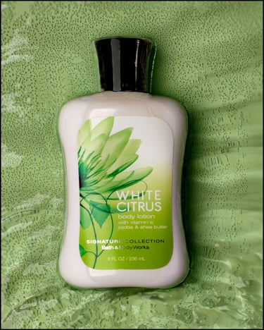 Whit Citrus lotion in bright muted green background.