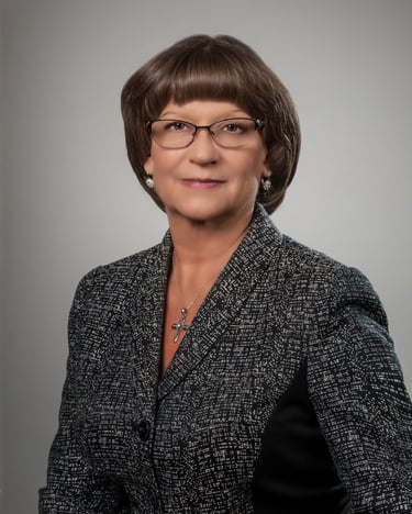 Beautiful Professionally dressed woman photographed on a light grey background for a magazine