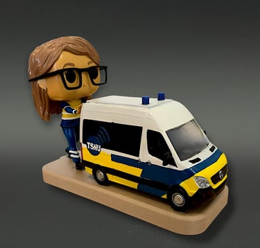 Customized Funko Pop doctor figure standing next to a detailed TSNU miniature medical van model.
