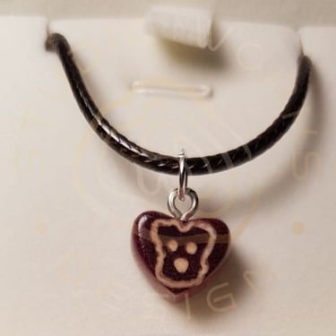 A tiny Schnauzer inlay into purple heart wood