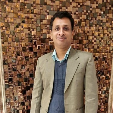 a man in a suit and tie standing in front of a wooden paneled wall