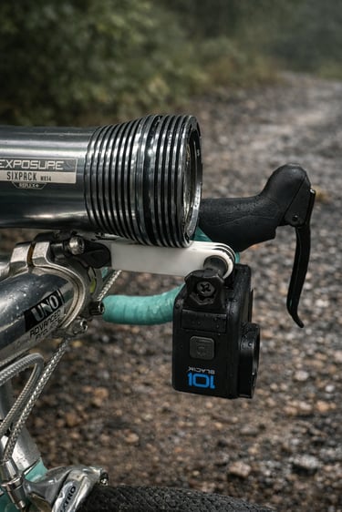 A GoPro Hero 10 action camera and Exposure Six Pack bike light mounted on gravel bike handlebars.