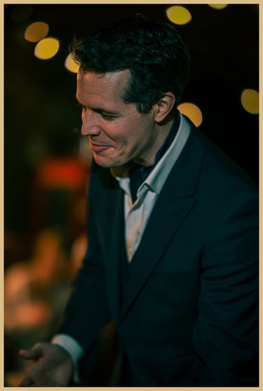 A smiling Maxwell Pritchard performs magic.