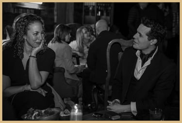 Maxwell Pritchard performing a magic effect for a smiling lady.