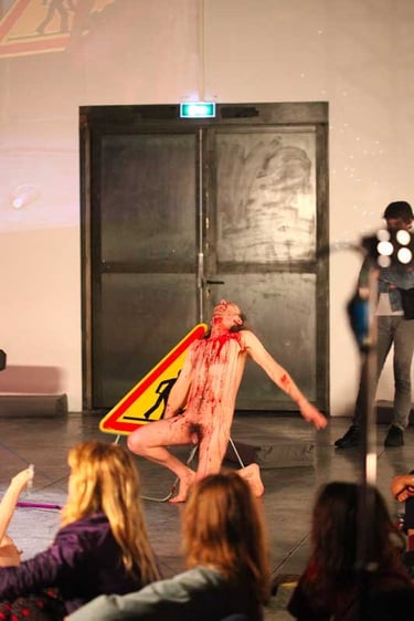 Adrien ensanglanté devant un panneau de chantier | Mobil'Homme | David Noir | Photo Bernard Bousquet