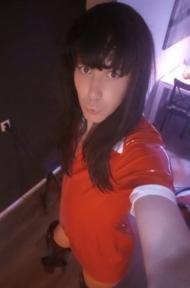 Dutch Sissy Slut Margo in a red PVC dress and black thigh high boots