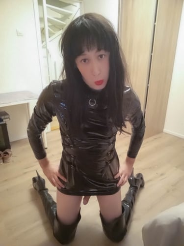Dutch sissy margo wearing a black pvc outfit and black thigh high boots kneeling on the floor