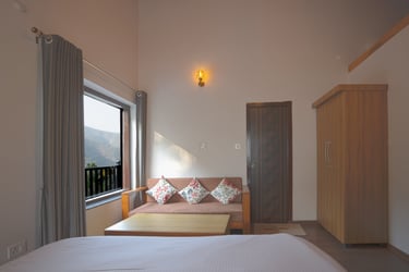 Deluxe Balcony Room with Sofa, table and wardrobe