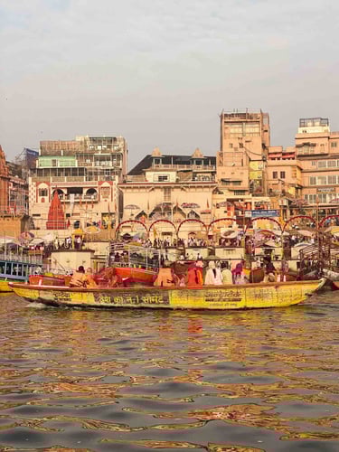 Group of Indians on a boat ride along the Ganges River in Varanasi, India.