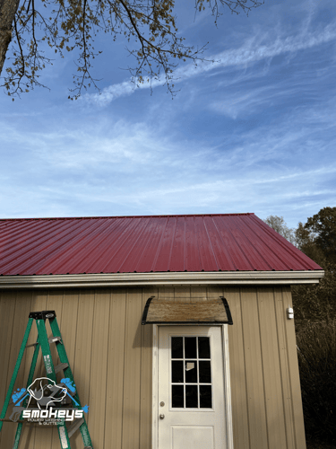 A red metal roof after a soft wash cleaning