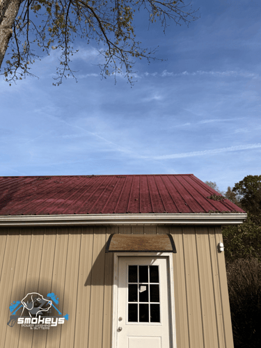 A red metal roof before a soft wash cleaning