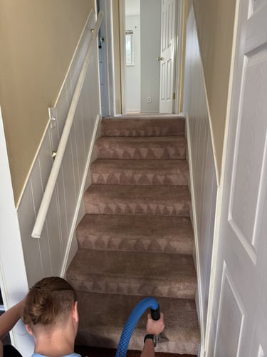Steamaster technician cleaning residential carpeted stairs in Mid-Michigan