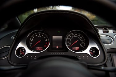 Lamborghini instrument cluster pictured between steering wheel