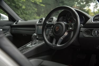 Porsche car interior picture taken from driver door open from a low angle
