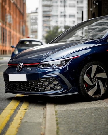 VW Golf mk8 GTI front quarter departing in a city setting