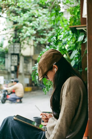 Women sitting outside on tablet