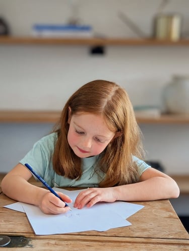 Primary aged child practicing English work for primary tuition in Kent