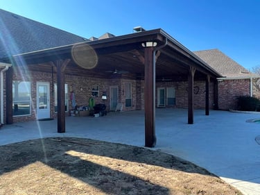 Large covered patio with dark wood posts.