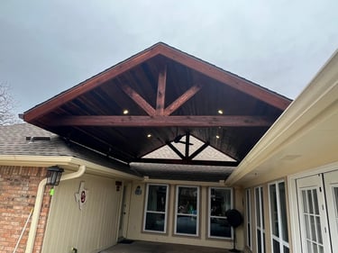 Covered patio with vaulted wood ceiling.