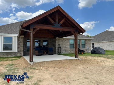 Covered patio structure with exposed wooden beams.