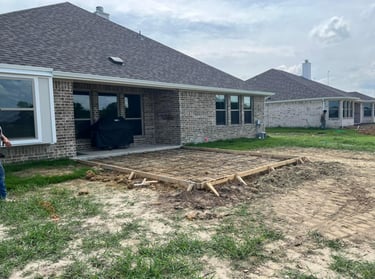 Concrete patio formwork with rebar in place.