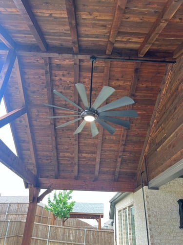 Covered patio ceiling with large modern ceiling fan.