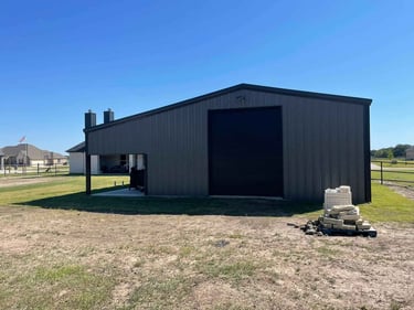 Large metal shop with roll-up door.