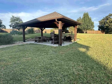 Wooden pavilion with outdoor seating.
