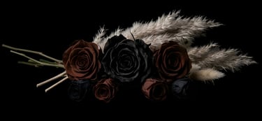 Elegant bouquet of black and brown roses with pampas grass on a dark background.
