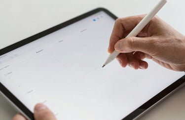 A close-up shot of hands using a stylus on a modern tablet to organize a digital planner. Bright, clean, professional photography with a tech-forward feel.