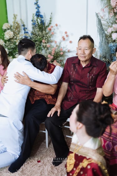 เจ้าบ่าวก้มกราบและกอดผู้ใหญ่ในพิธีแต่งงานล้านนา จังหวัดน่าน