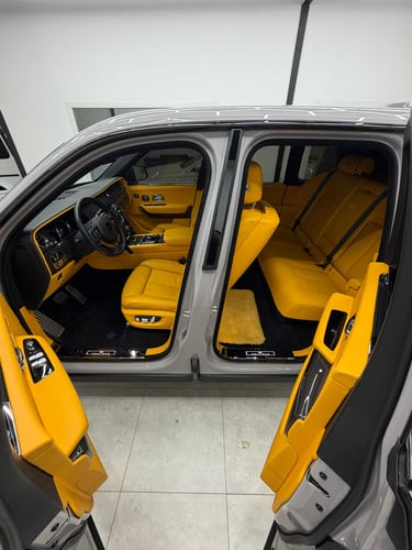Luxury SUV interior with vibrant yellow leather seats and premium cabin features.