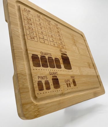 Bamboo cutting board featuring an engraved kitchen measurement conversion chart for liquid and dry units.