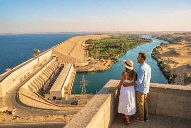 A couple overlooks the Aswan High Dam and Nile River from a scenic viewpoint in Egypt.