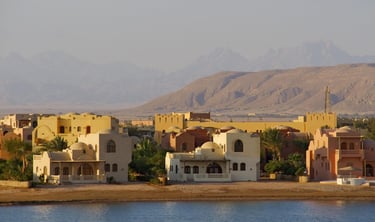 Luxury desert resort villas on the Red Sea coast in El Gouna, Egypt with mountain backdrop.