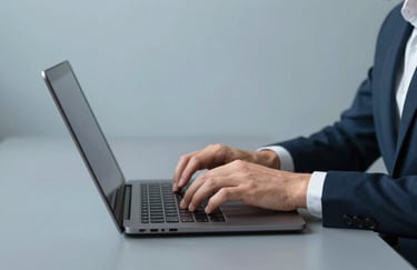 A professional person typing on a premium laptop in a clean North American / US coworking space, minimalist Muted Steel Blue desk background.