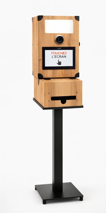 Modern wooden photo booth kiosk with touchscreen display and built-in printer for events.