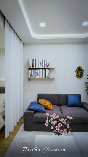 Modern apartment living room with blue sofa, wall shelves, and warm ceiling lighting — photorealistic 3D interior render by T