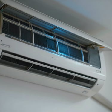 Close-up of a clean air conditioner vent with soft blue light, showing a fresh and dust-free interior with cool air flowing.