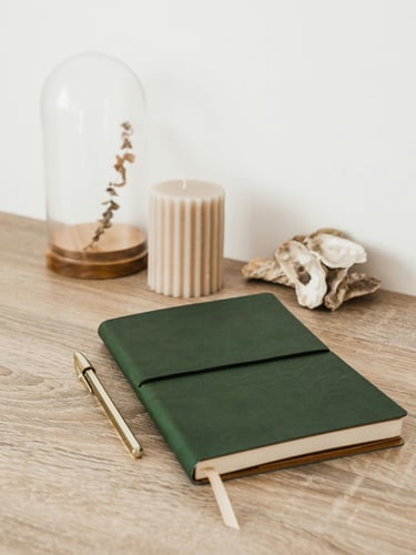 green notebook on wood table