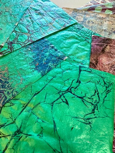 Green hand-painted collage papers with layered paint texture