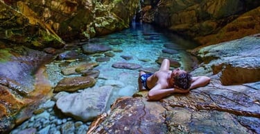 A man enjoying sun through an opening inside the Golubinka cave.