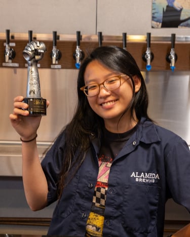 Yan Hui posing with the Best Rebrand Trophy from Craft Beverage Marketing Awards.