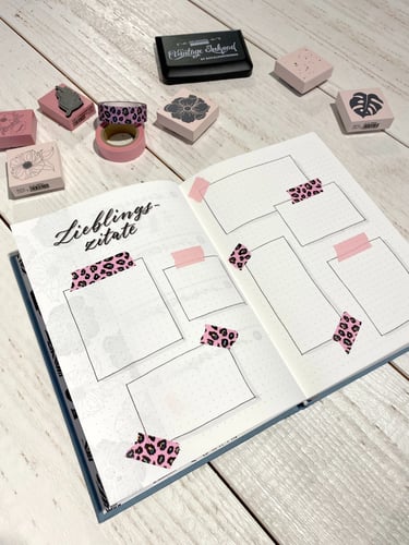 Bullet journal spread for quotes with leopard print washi tape and floral rubber stamps.