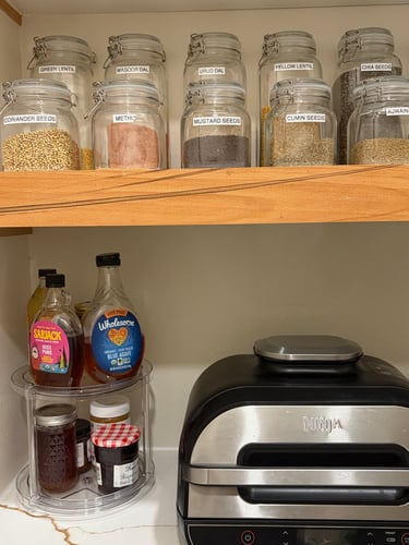 Kitchen spice organization with labeled glass jars for a clean and functional kitchen storage system