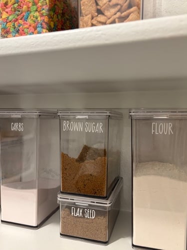 Close up of acrylic pantry storage bin with custom label for organized kitchen storage