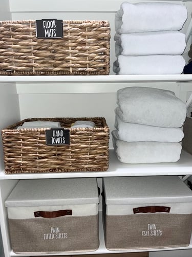 Linen closet organized by professional organizer